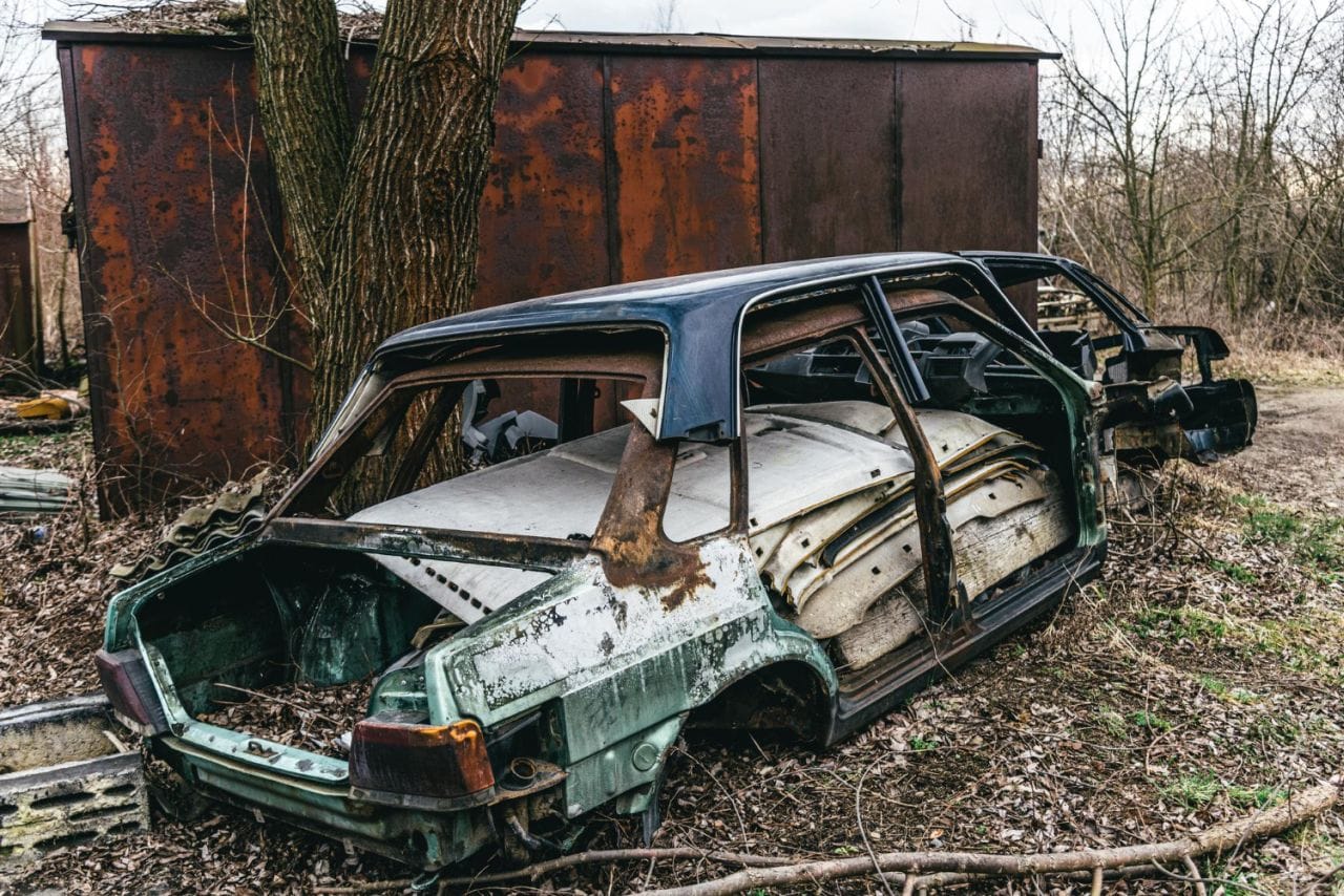 dump broken rusted cars their parts tires