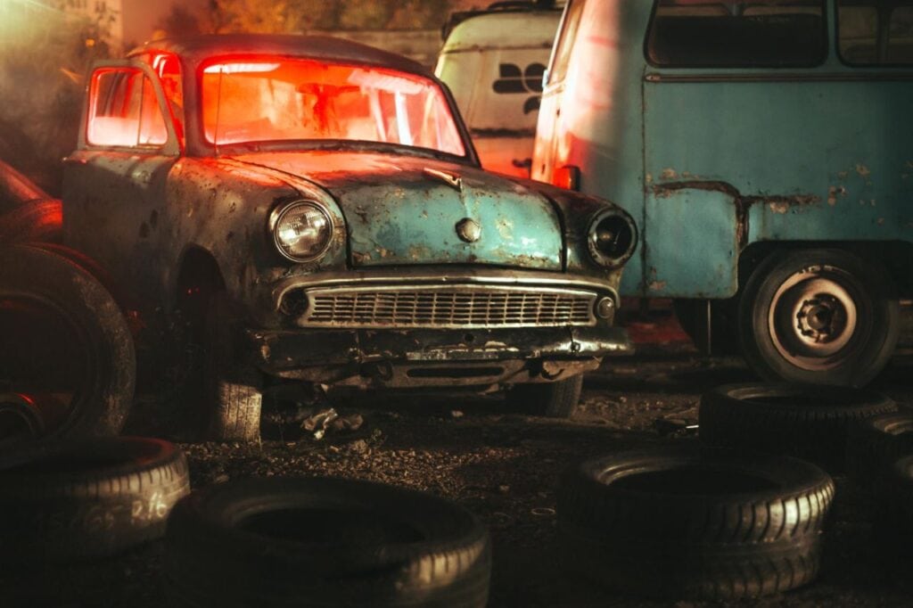 old abandoned car junkyard night with red light